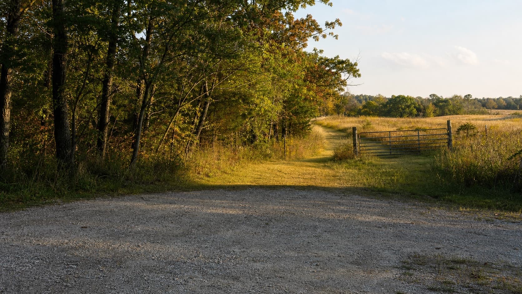 Gravel parking pull-off and field gate for a day hunting lease guide